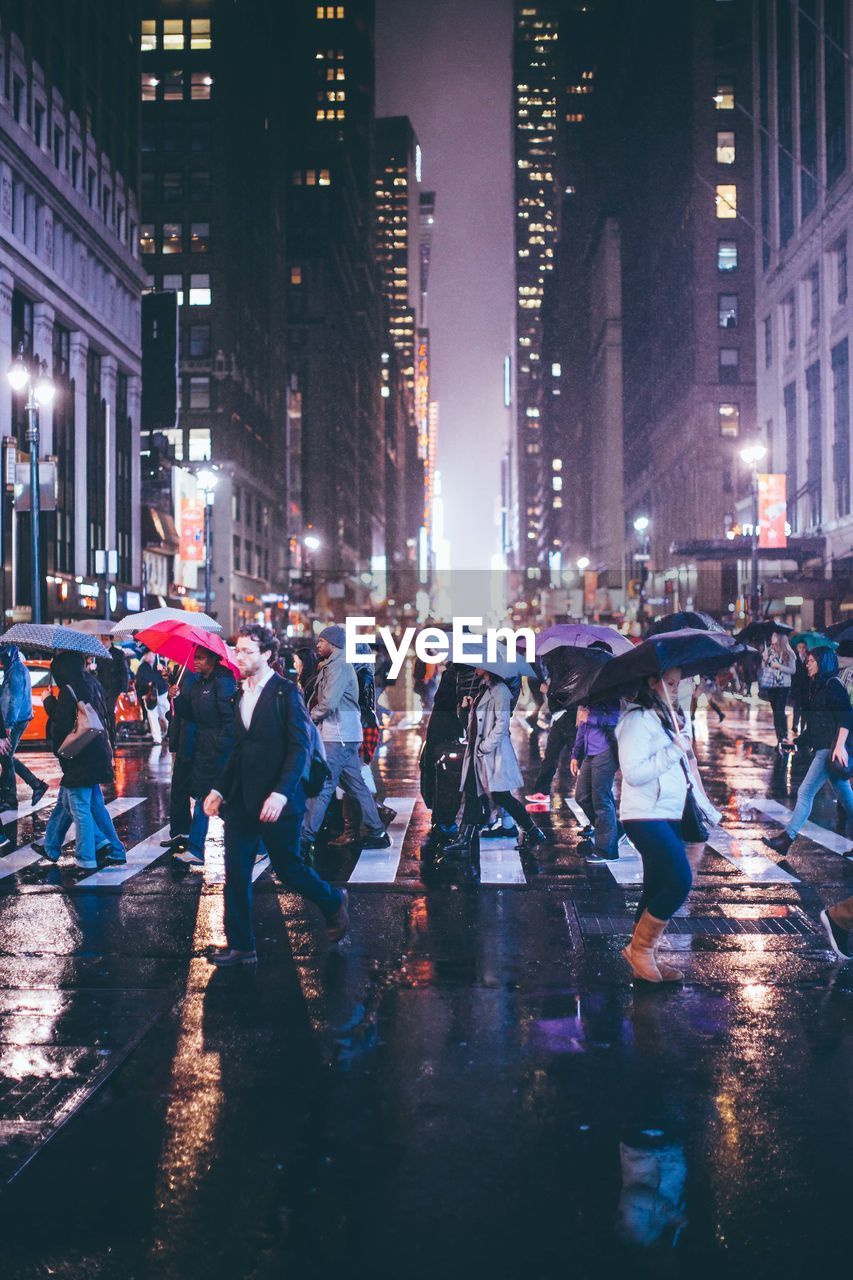 Crowd on wet road at night