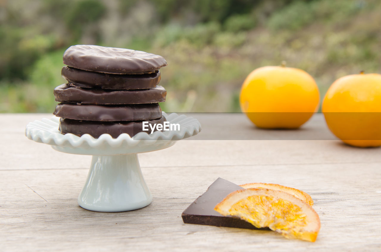 Close-up of chocolates with oranges on table