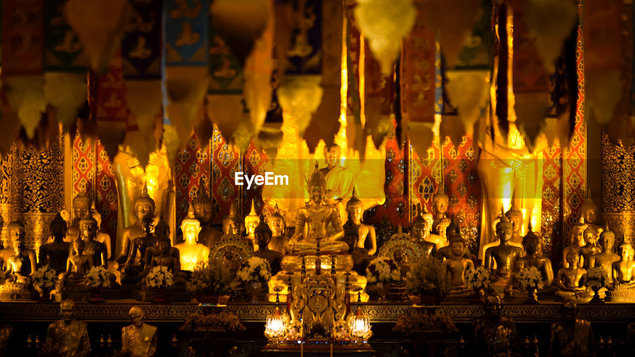 Buddha statues in illuminated temple