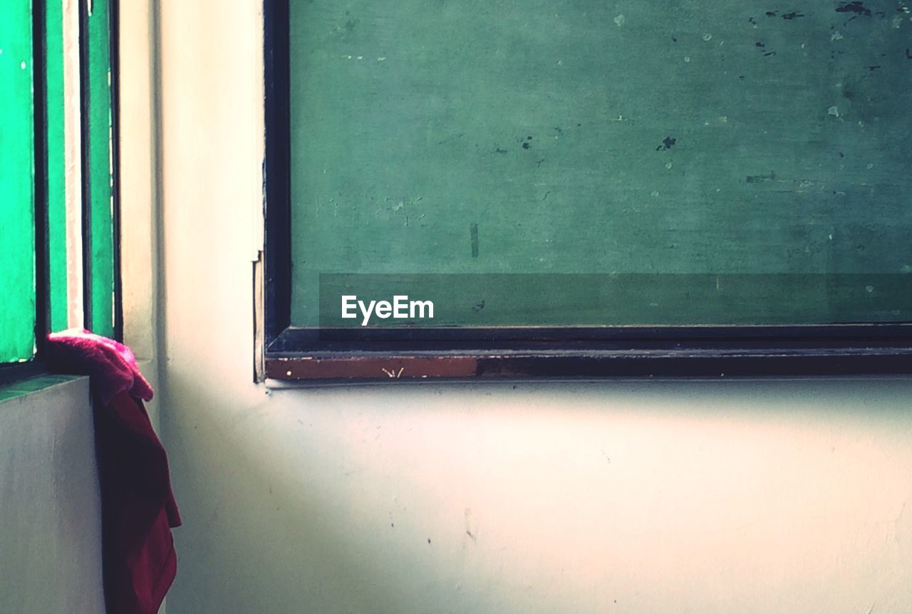 Blackboard by window in classroom