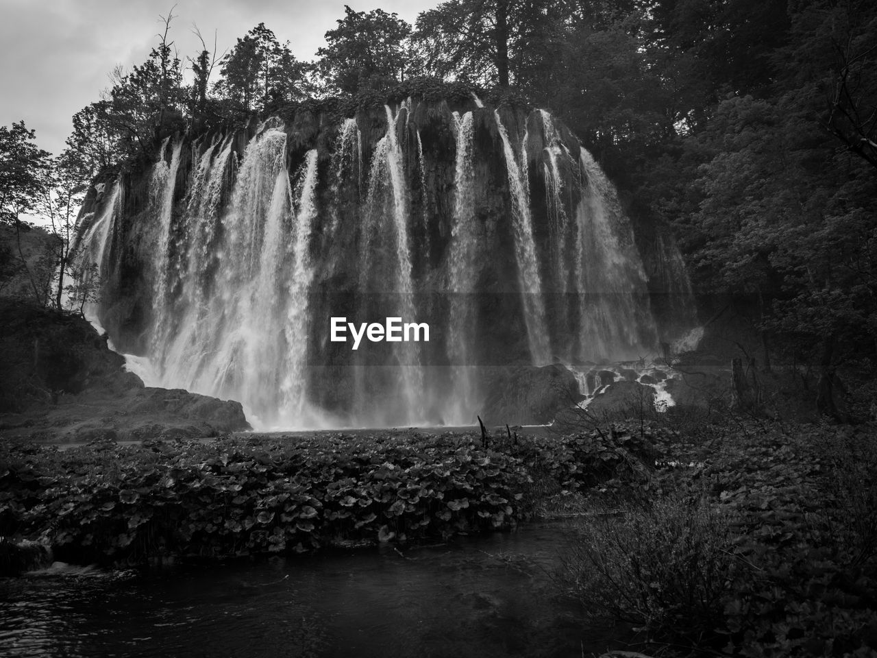 Low angle view of waterfall against sky