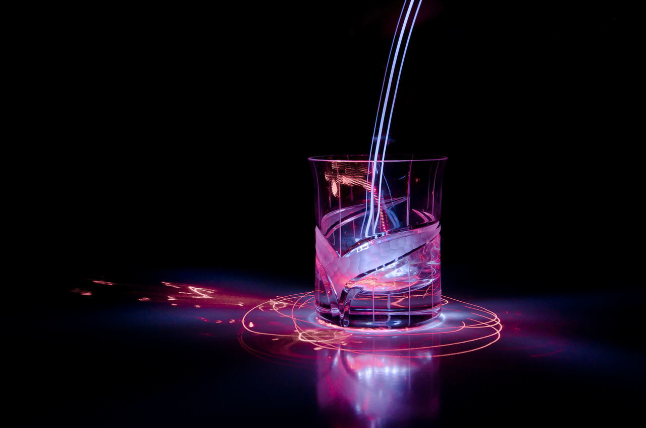 CLOSE-UP OF ILLUMINATED RED LIGHT AGAINST BLACK BACKGROUND