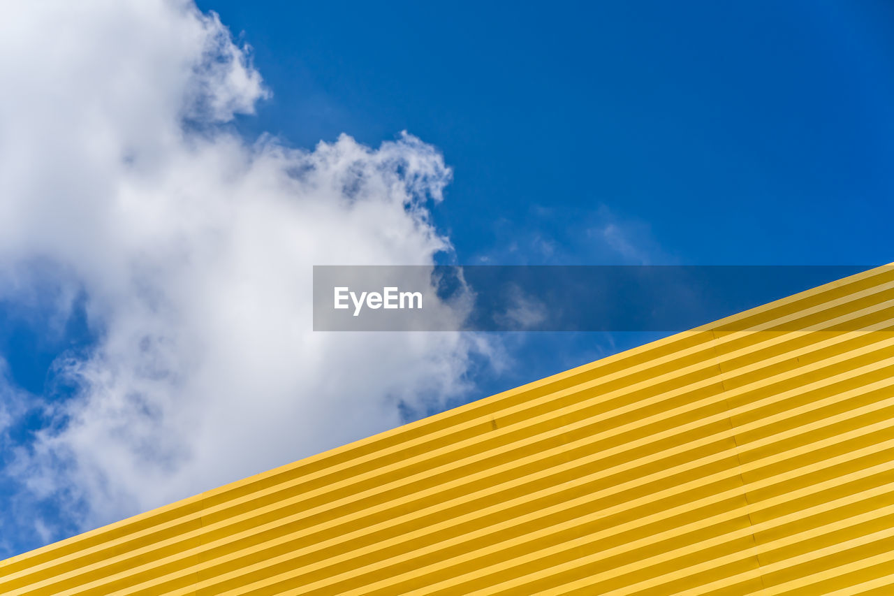 Low angle view of yellow roof against sky