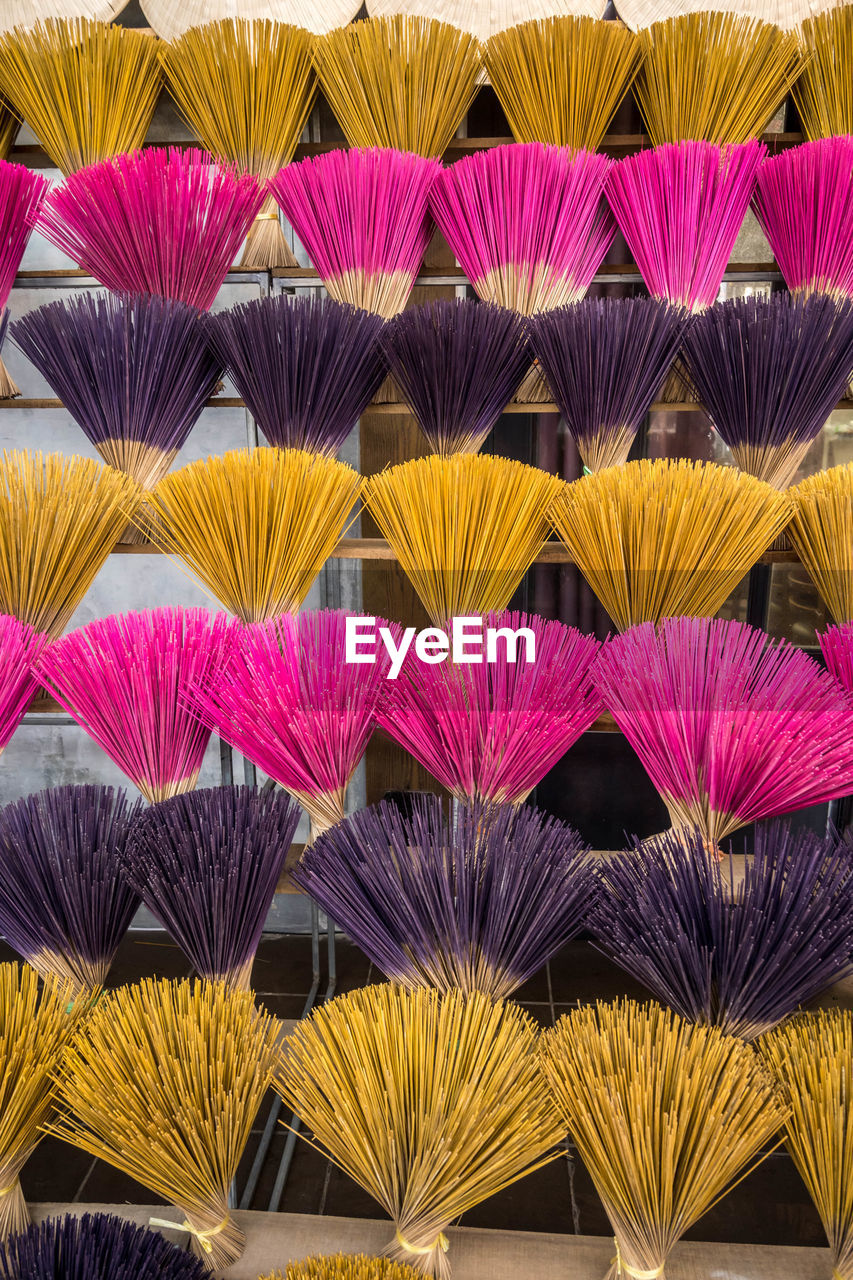 Bouquets of colorful incense sticks made by hand. the incense sticks dry in the sun.