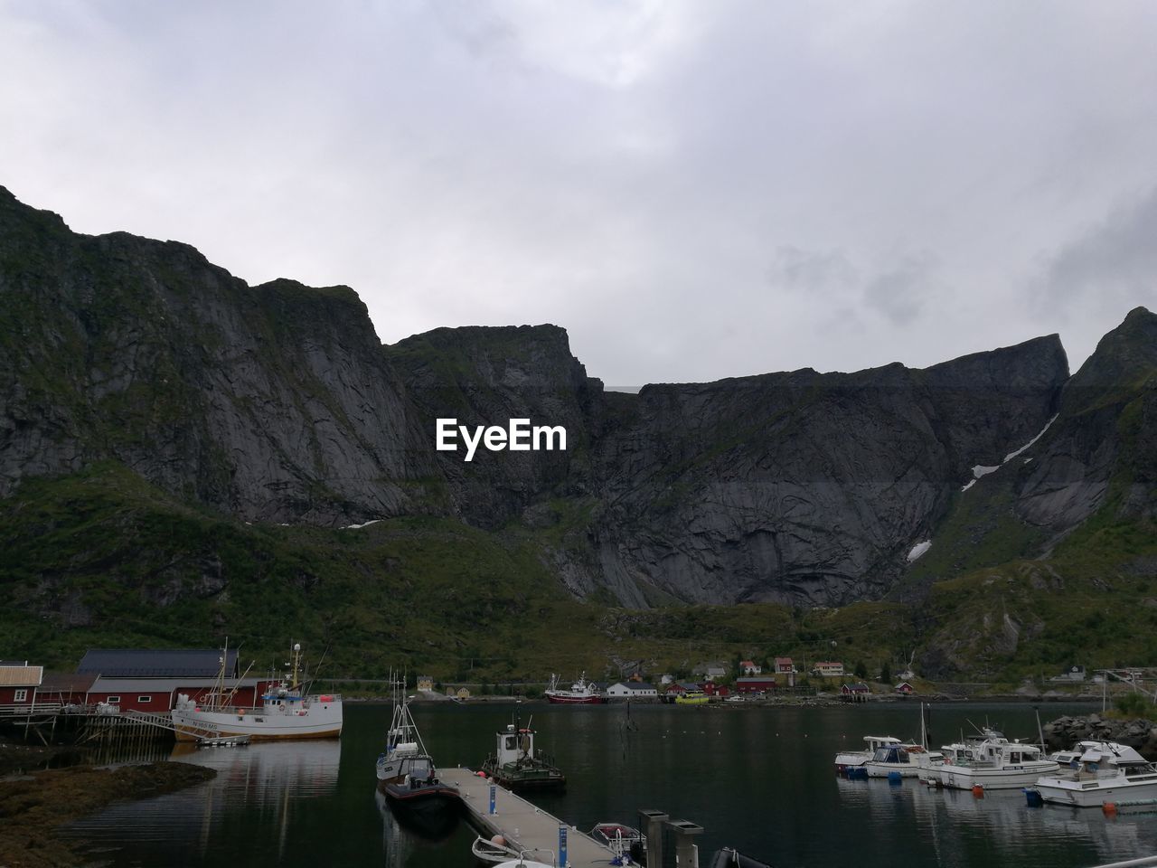 Scenic view of lake by mountains against sky