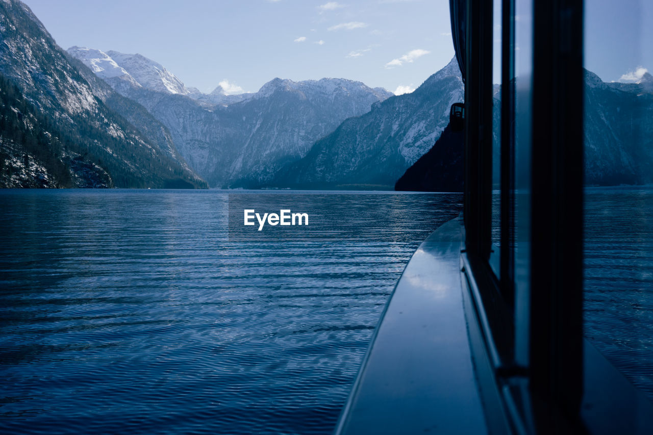 Scenic view of lake and mountains seen through window