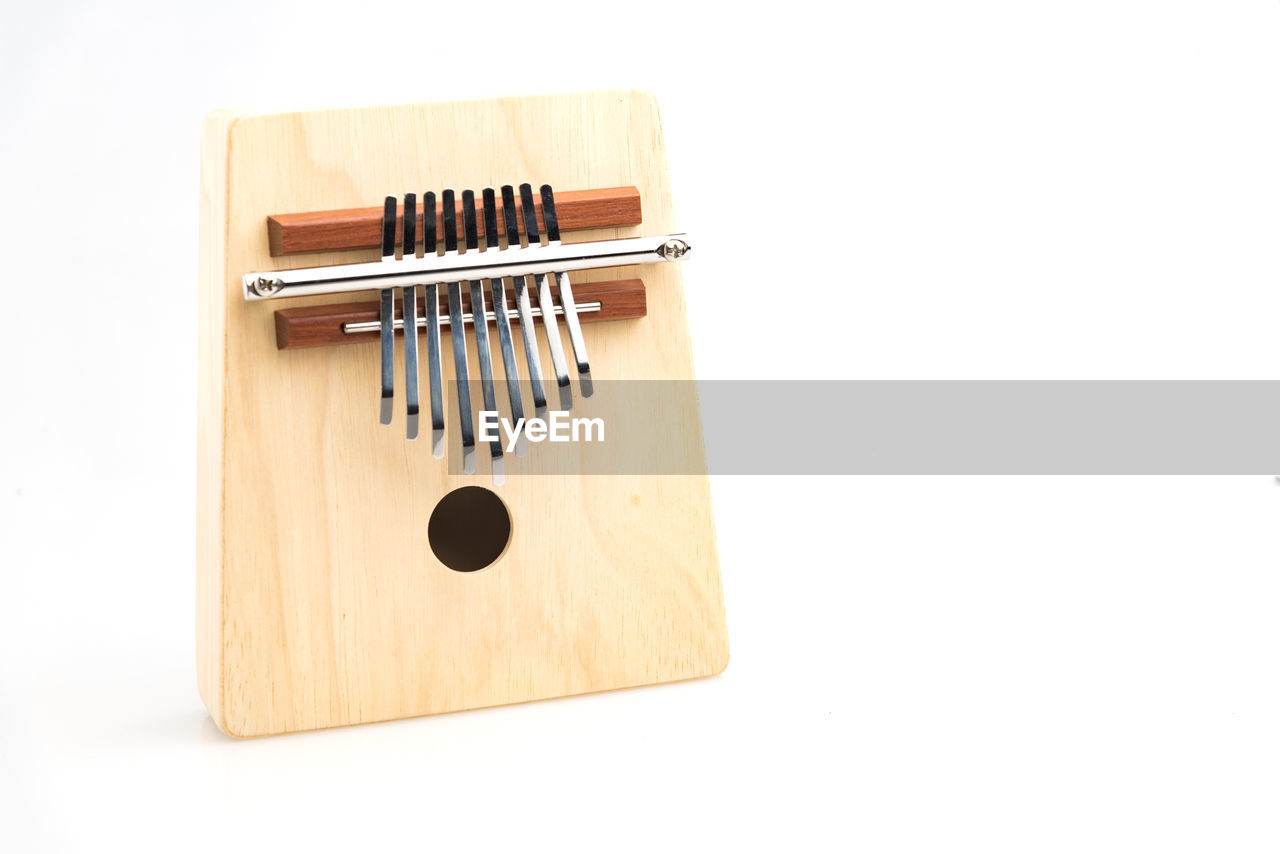 Close-up of mbira on white background