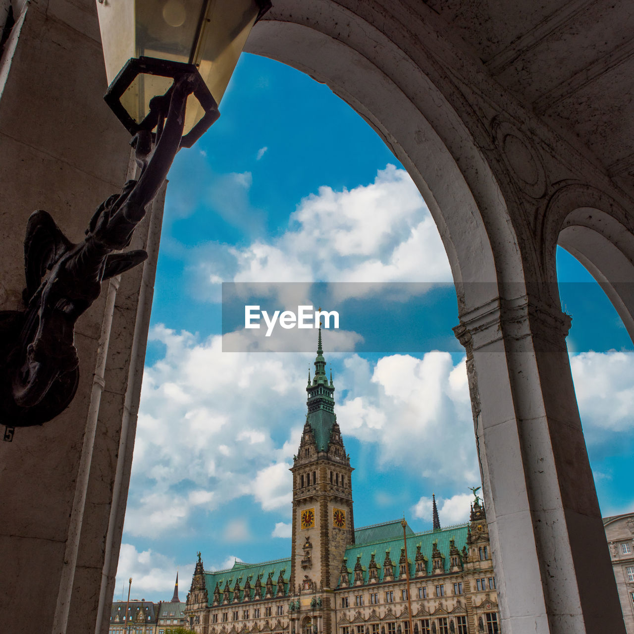 Low angle view of hamburg city hall against cloudy sky