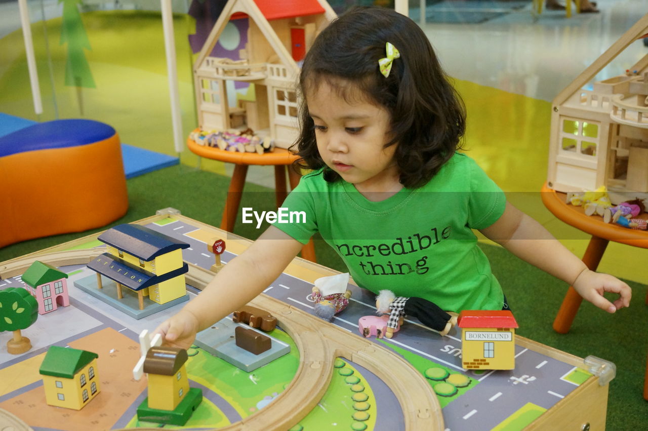 CUTE GIRL PLAYING WITH TOY