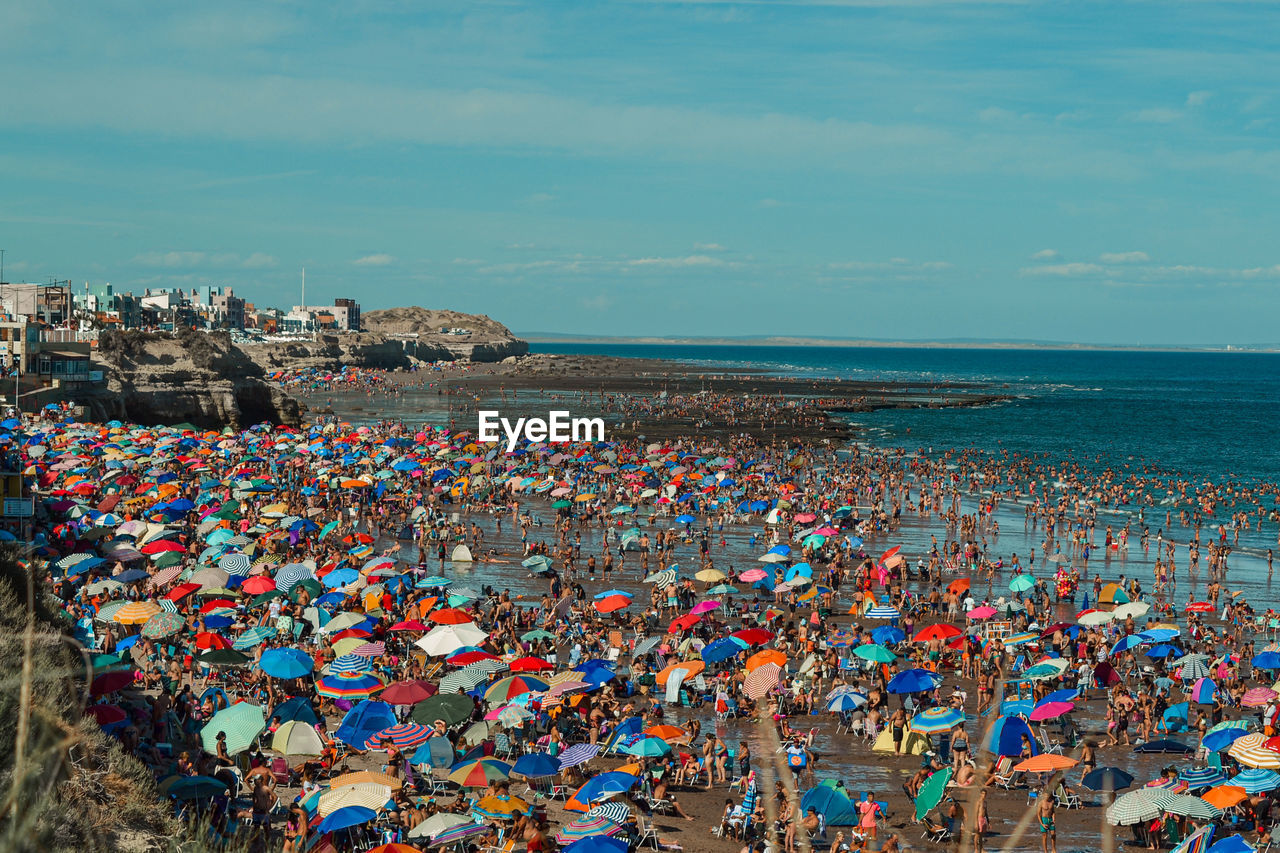 High angle view of people at beach against sky