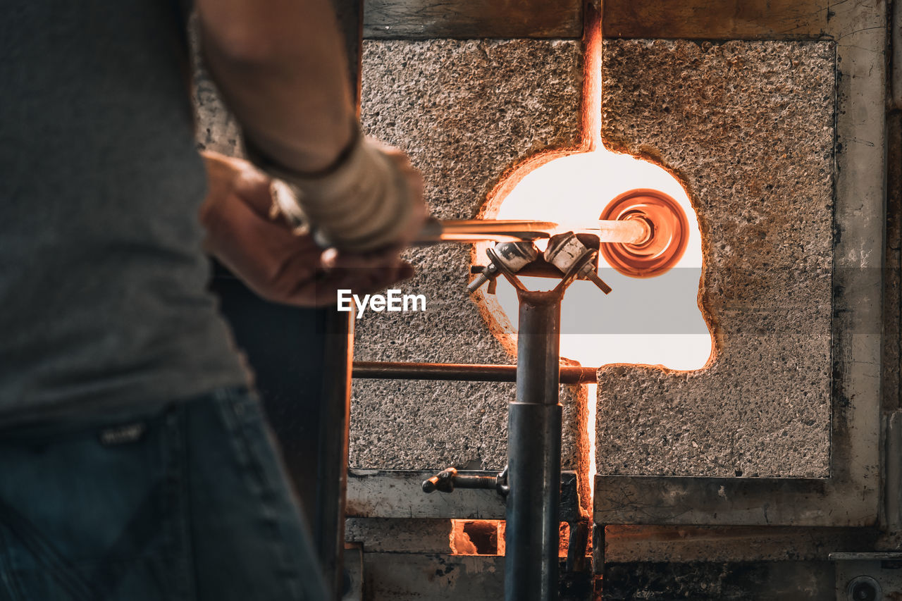 Manual worker making glass at workshop