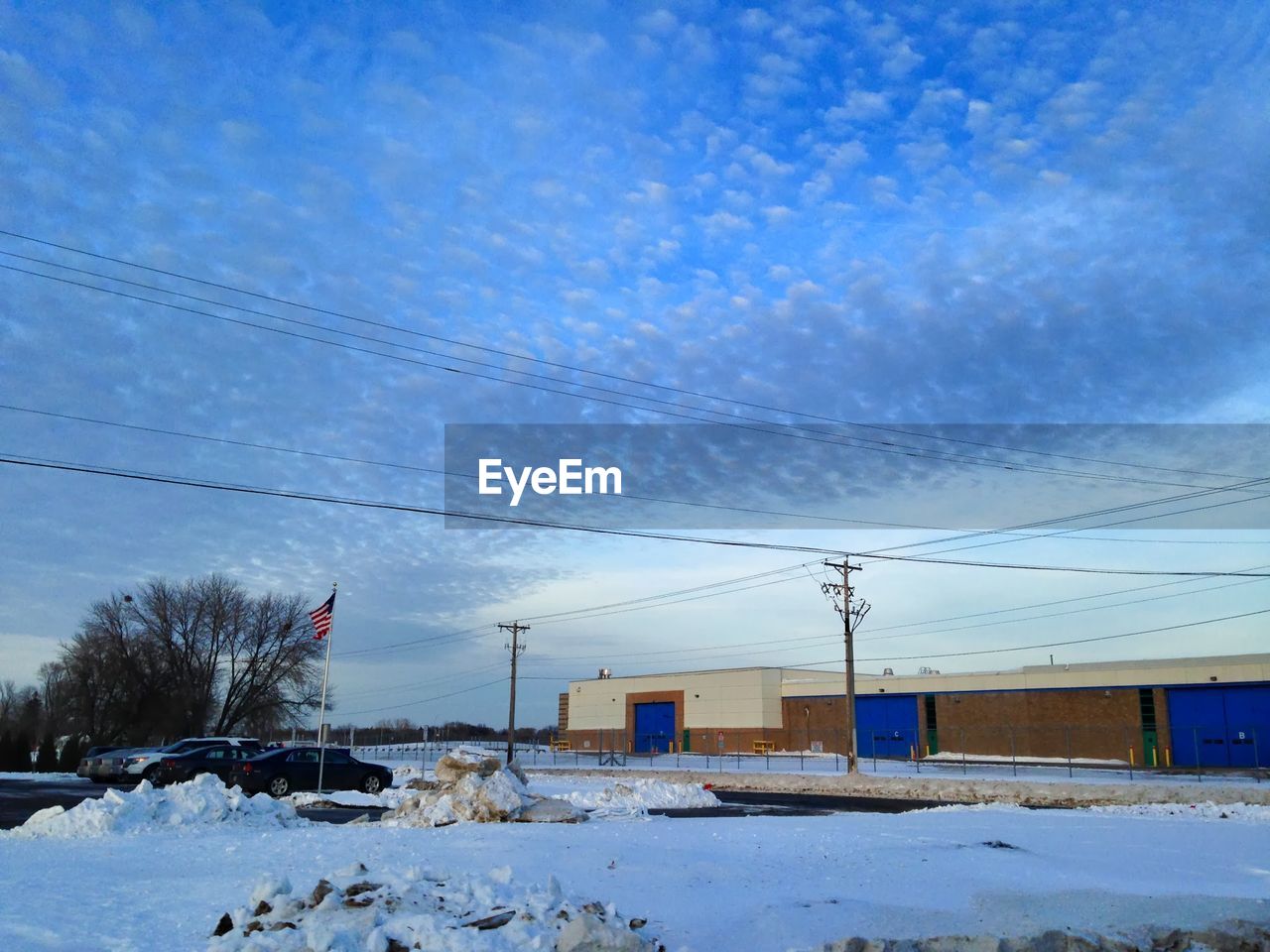 VIEW OF HOUSES AGAINST CLOUDY SKY