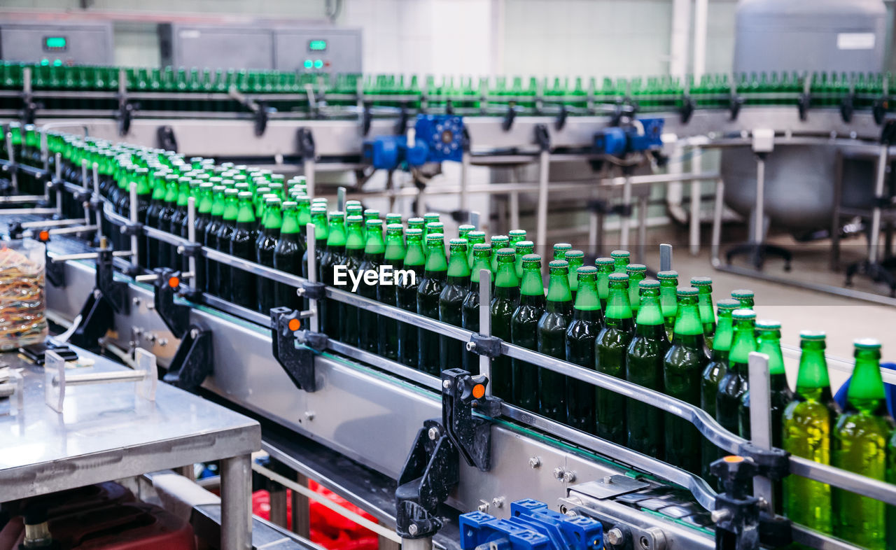 Close-up of bottles in factory