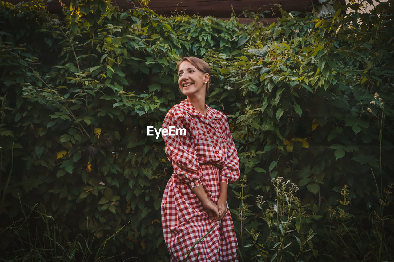 Portrait of a smiling young woman standing outdoors