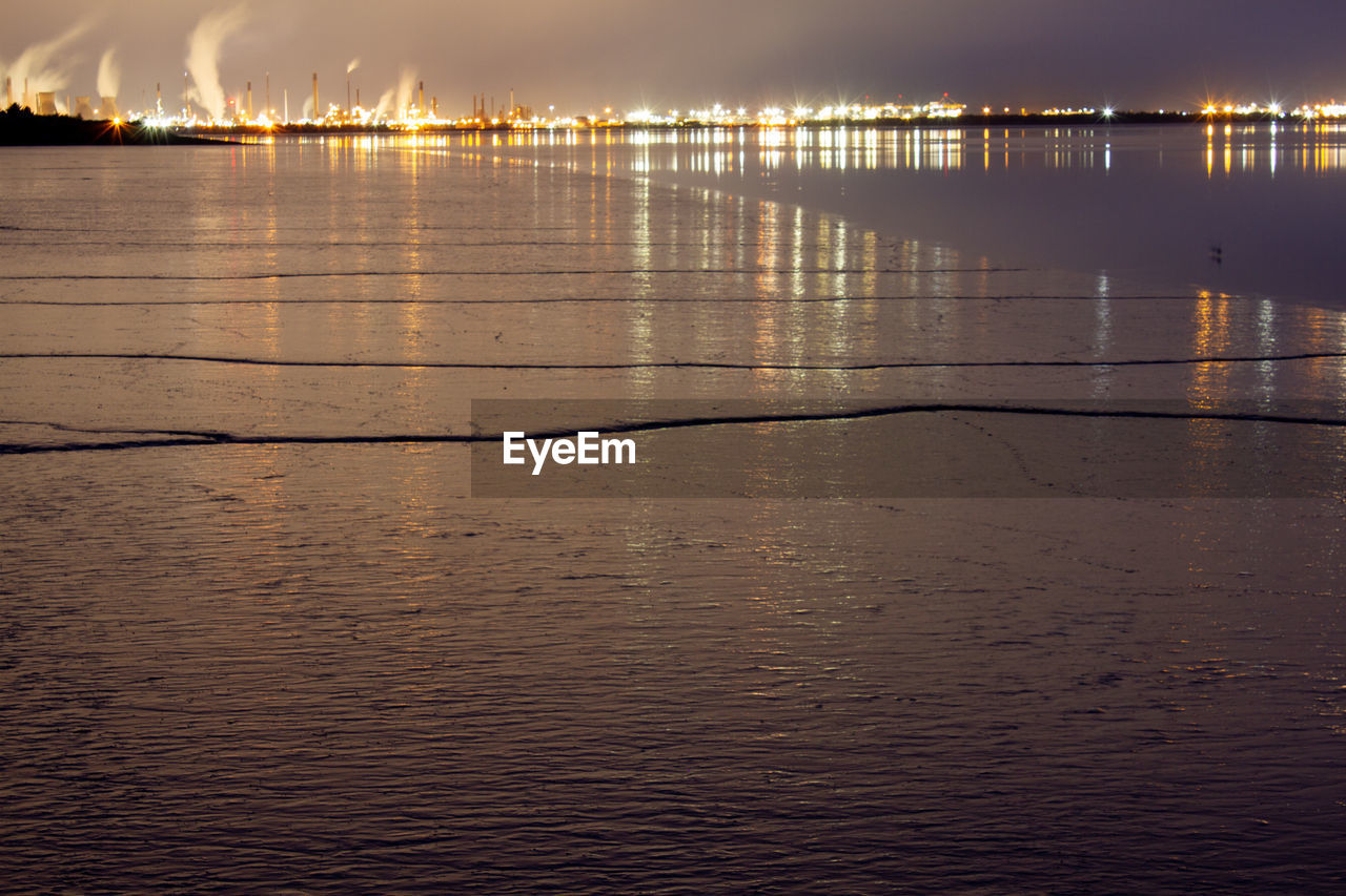 water, reflection, sky, morning, sea, dawn, horizon, nature, cloud, beauty in nature, sunrise, architecture, scenics - nature, sunlight, light, tranquility, no people, beach, environment, built structure, outdoors, tranquil scene, land, pier, city, wave, travel destinations, building exterior, illuminated, landscape, shore