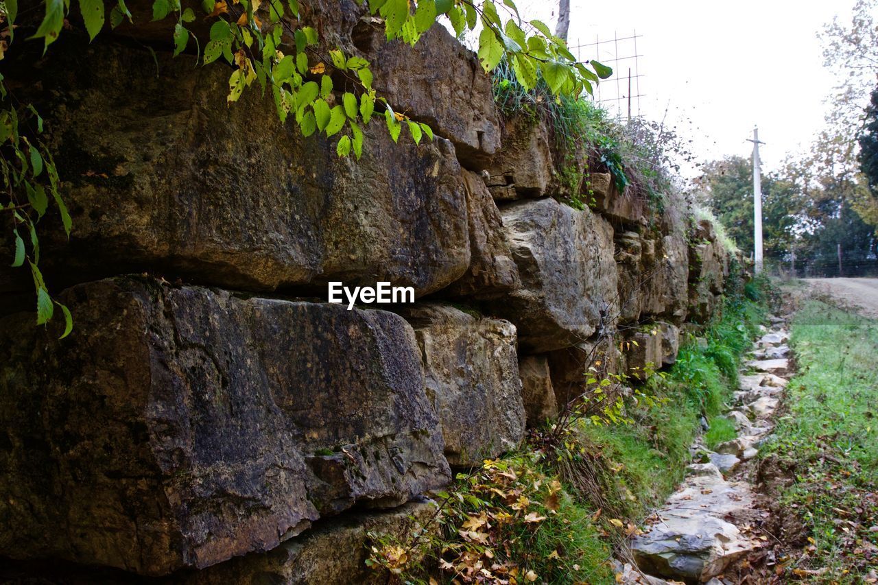 STONE WALL WITH ROCKS IN FOREGROUND