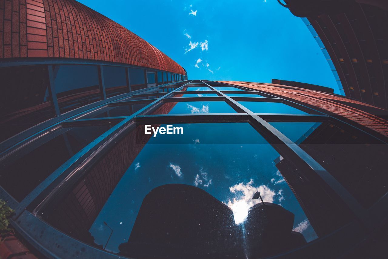 LOW ANGLE VIEW OF SWIMMING POOL AGAINST BLUE SKY