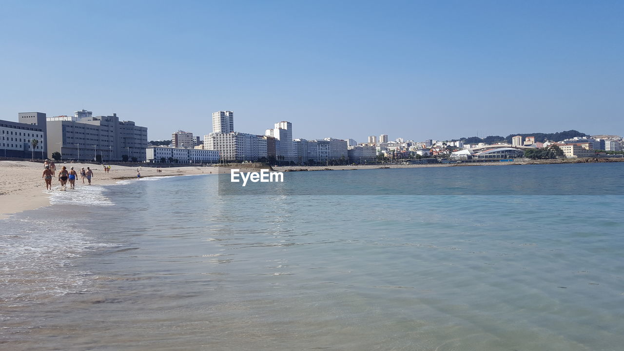 VIEW OF CITYSCAPE AGAINST BLUE SKY