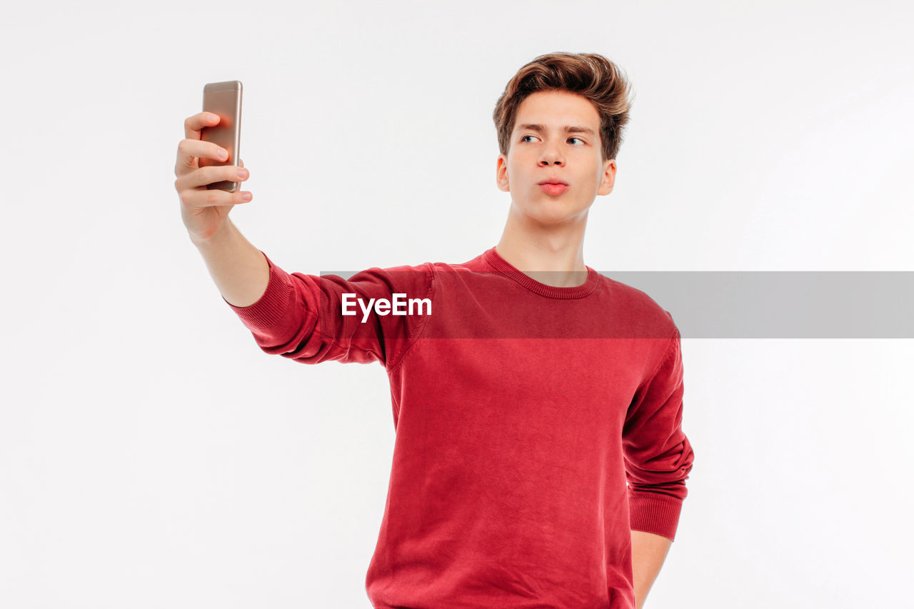 Young man selfie against white background