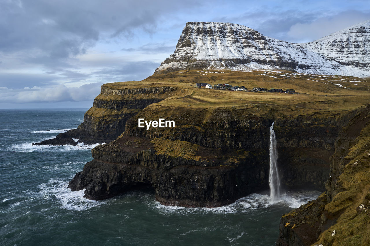 Scenic view of cliffs against sky