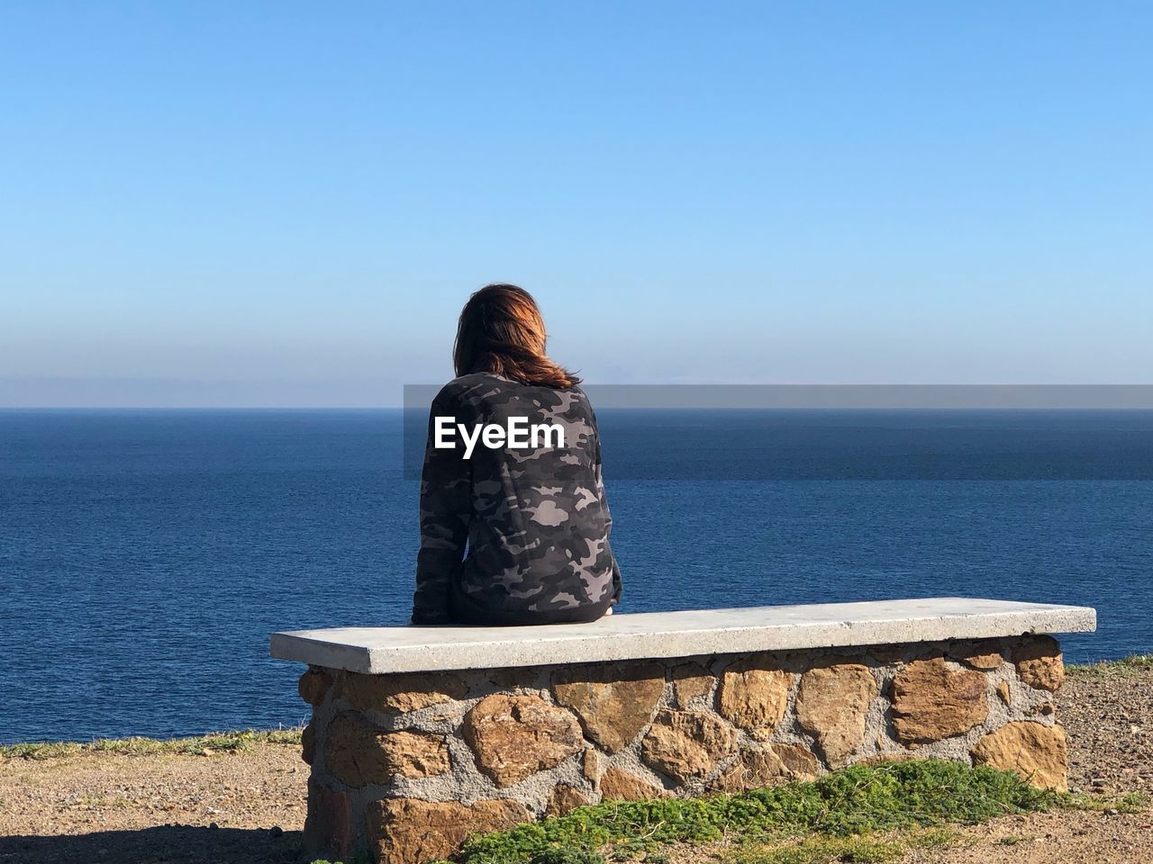 Rear view of woman looking at sea against sky