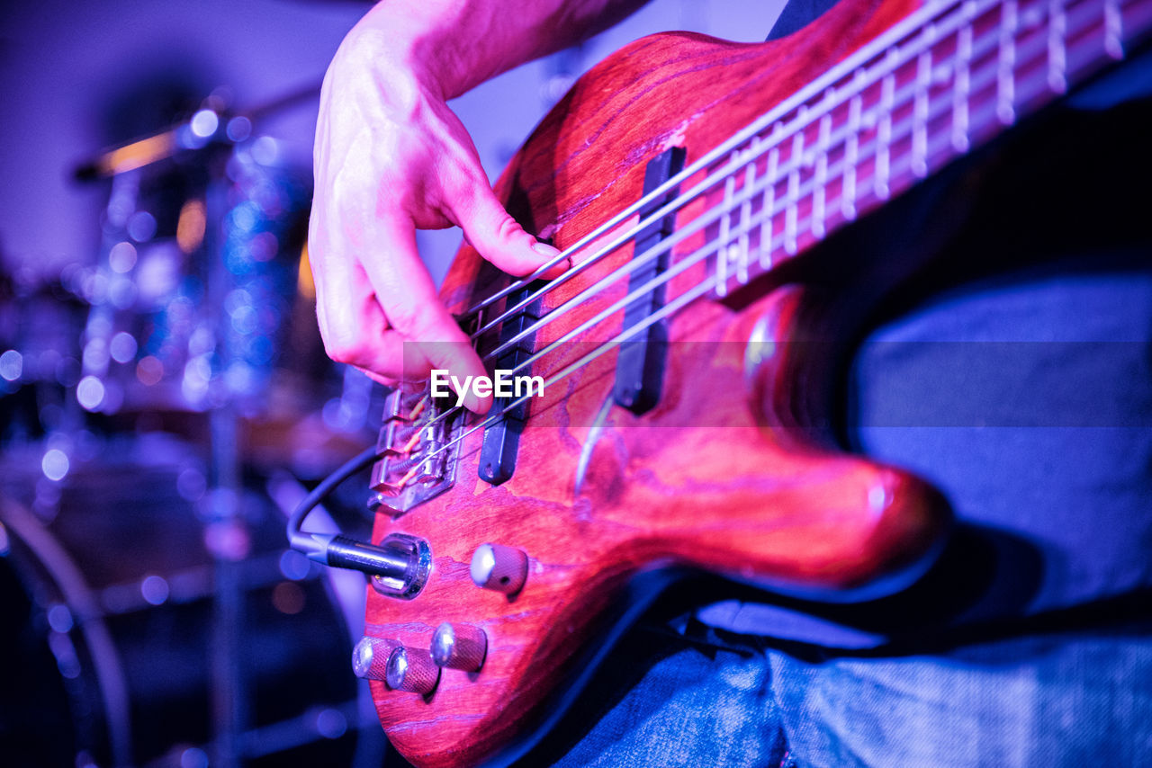 Cropped image of man holding guitar