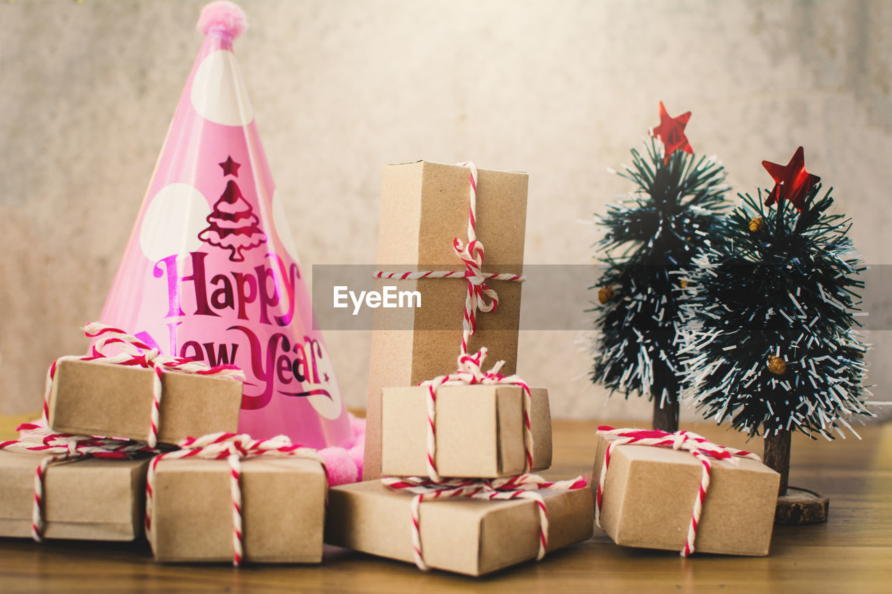 Close-up of christmas trees and gifts on table