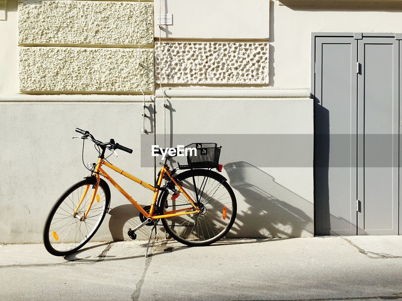 Bicycle parked on street outside house