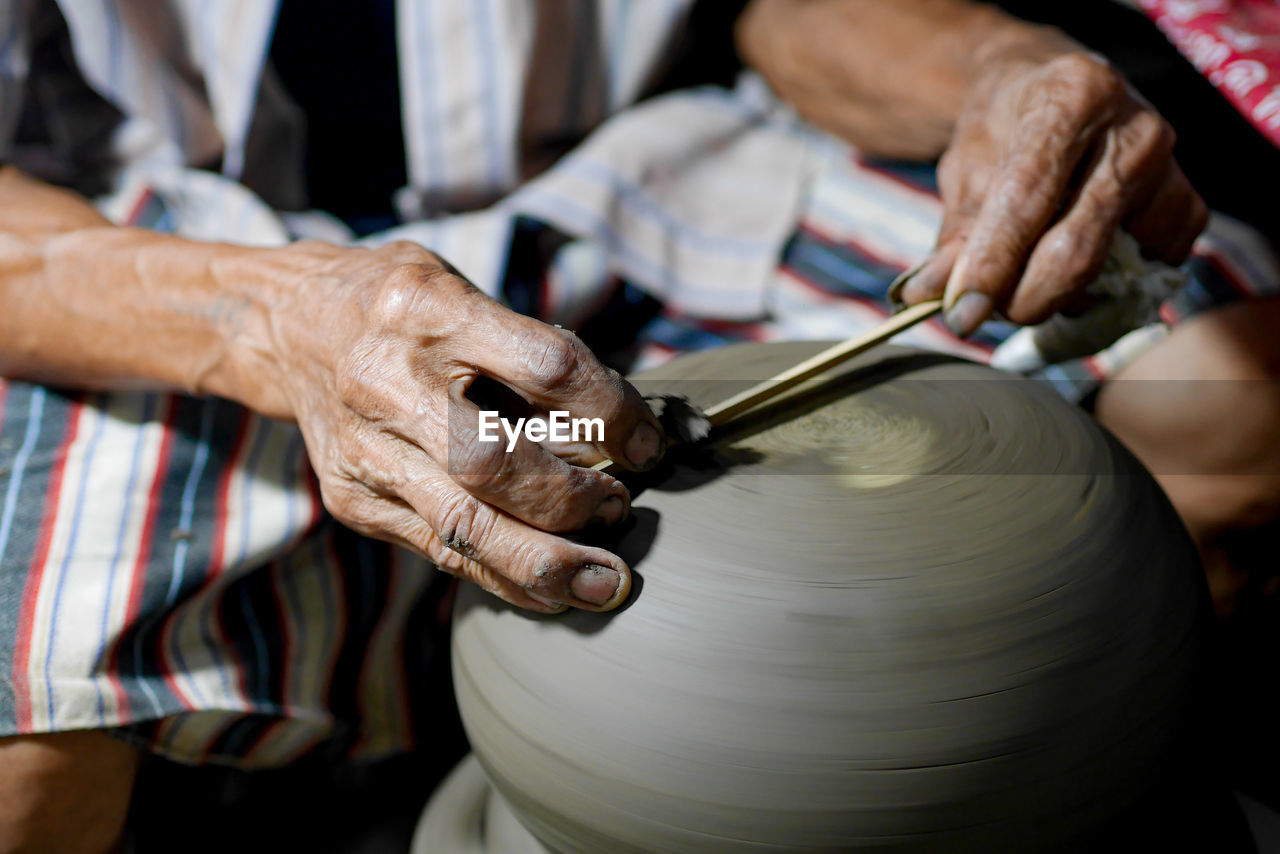 Close-up of man making pottery