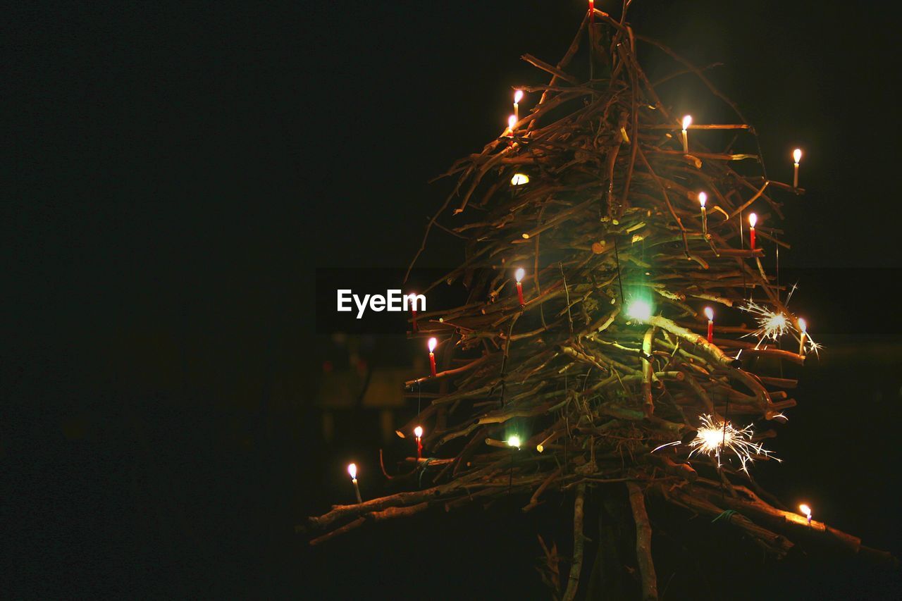 Low angle view of illuminated christmas tree at night