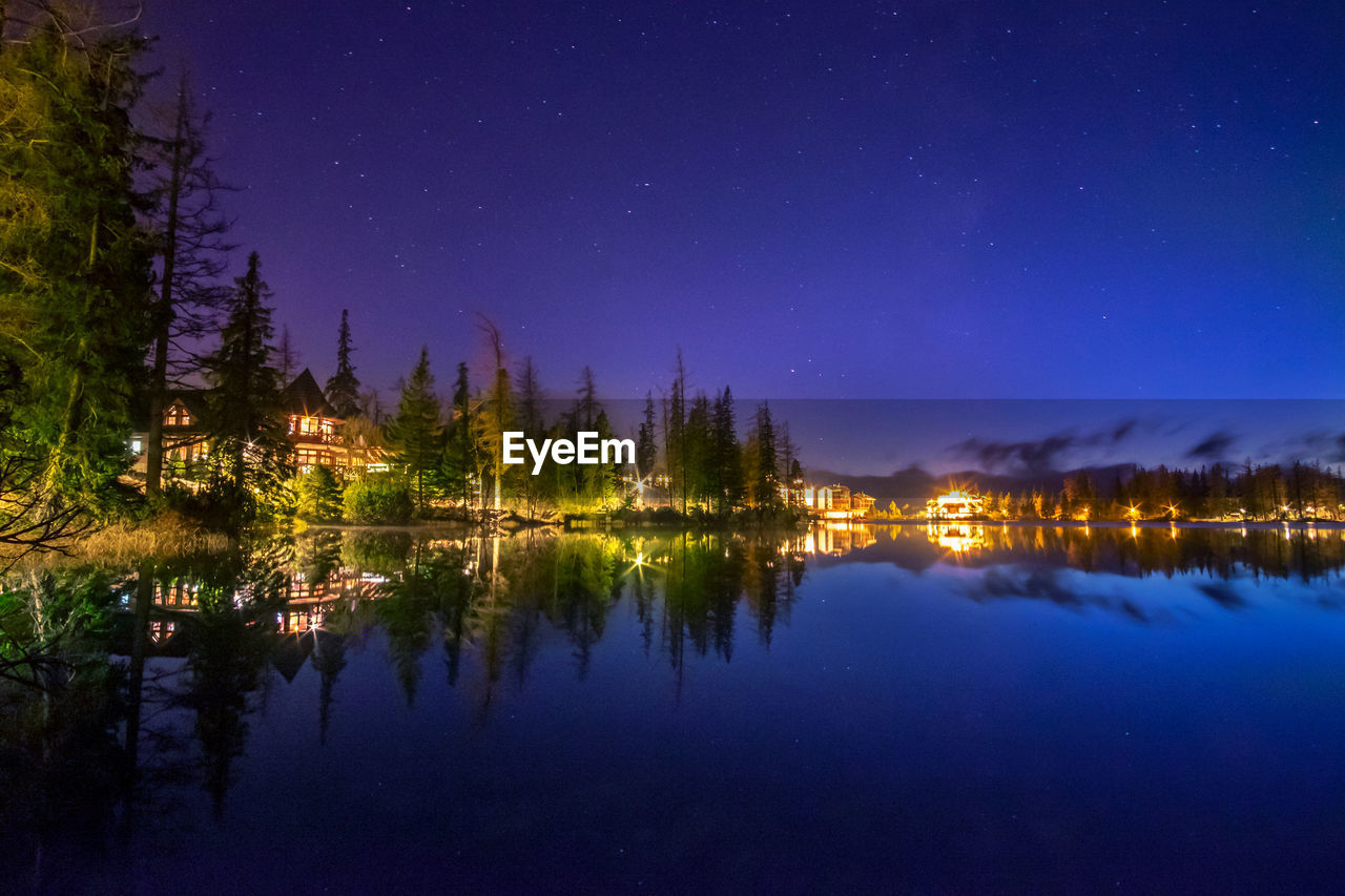 Scenic view of lake against sky at night