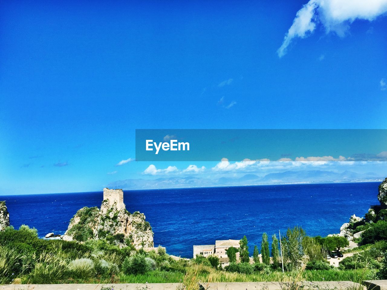 Scenic view of sea against blue sky