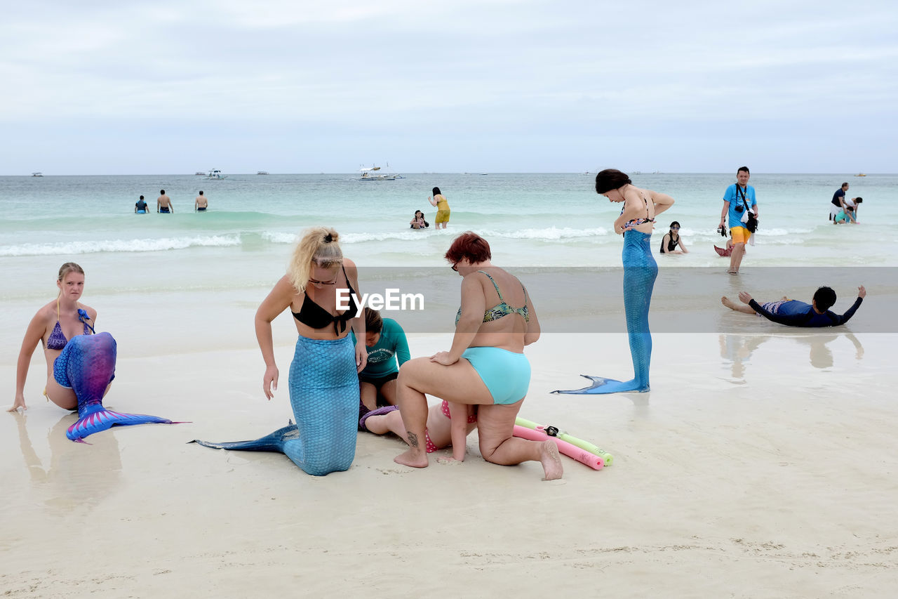 TOURISTS ENJOYING AT BEACH