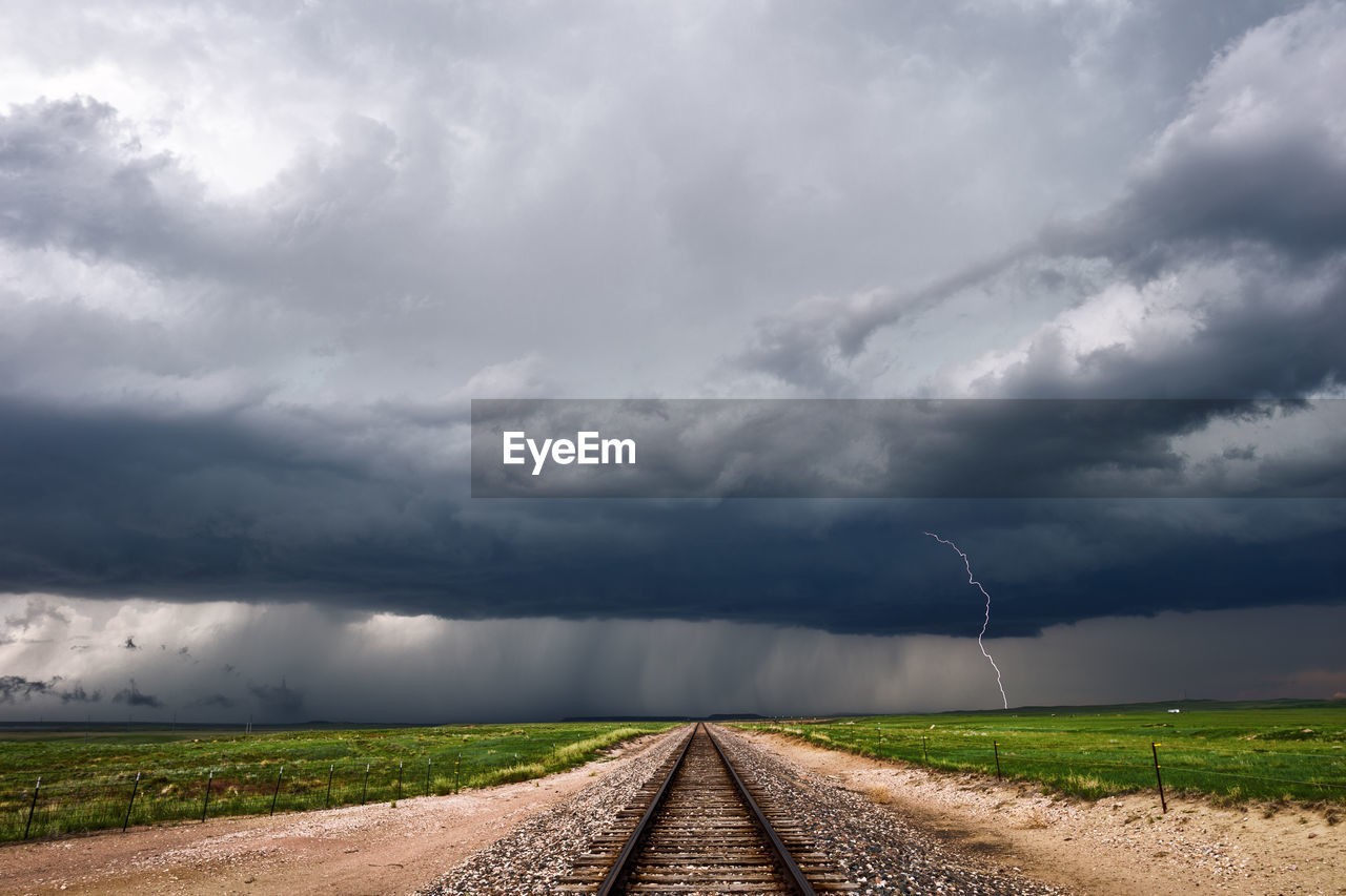 View of railroad track passing through field
