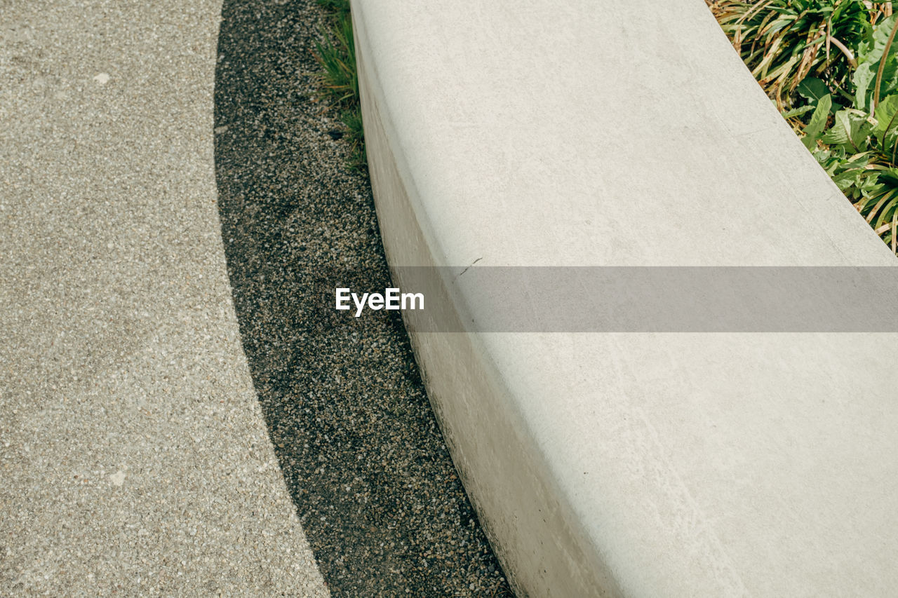 View from above on curved concrete bench