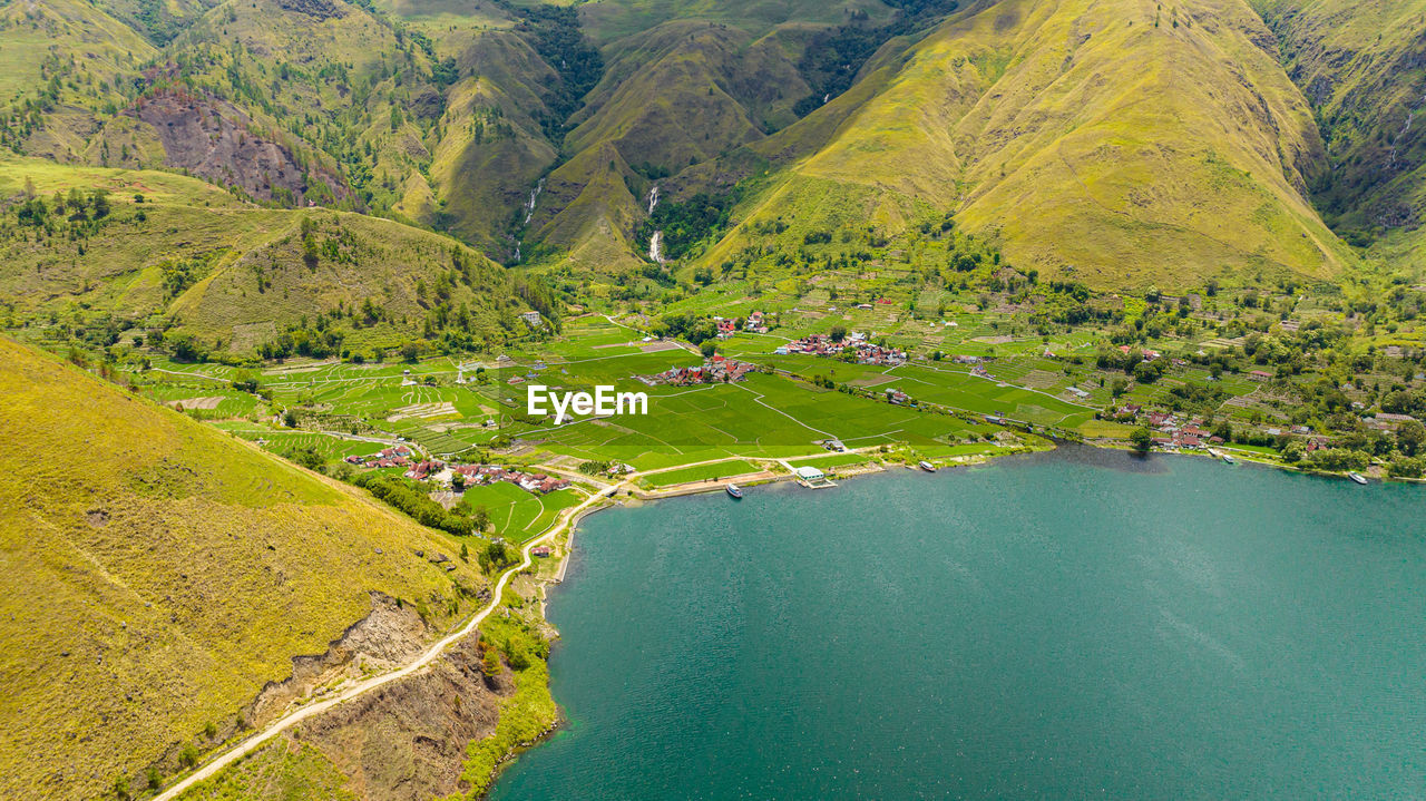 high angle view of rock formations by lake