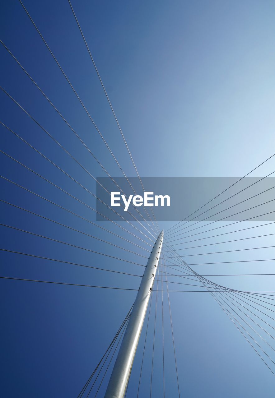 Low angle view of bridge against clear blue sky