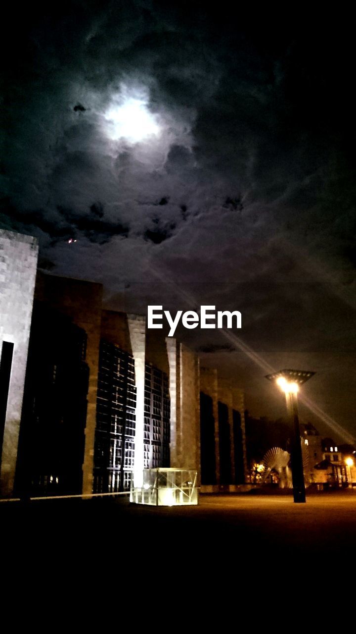 LOW ANGLE VIEW OF ILLUMINATED BUILDINGS AGAINST THE SKY