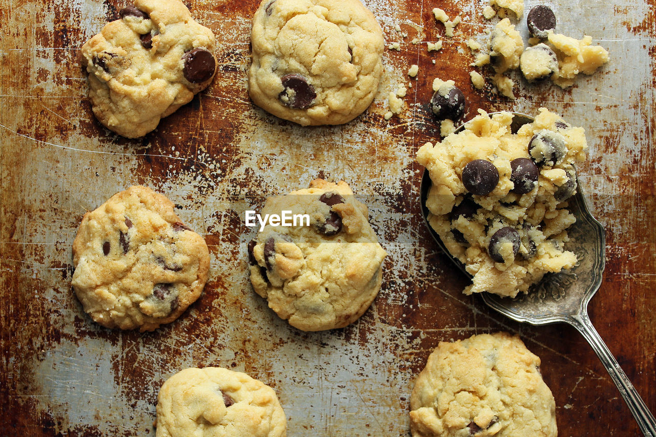 High angle view of cookies with spoon on rusty tray