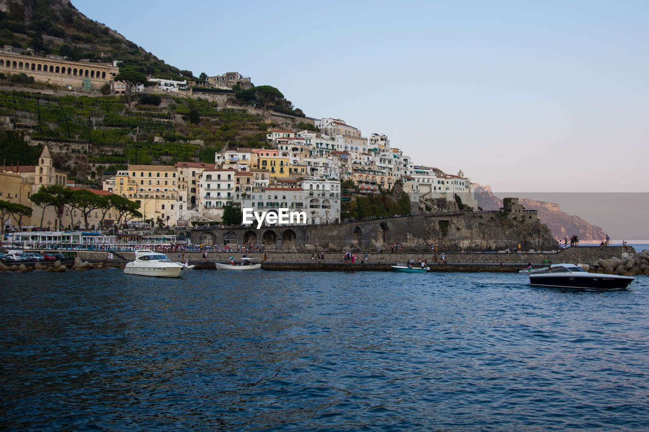 BUILDINGS BY SEA AGAINST CLEAR SKY