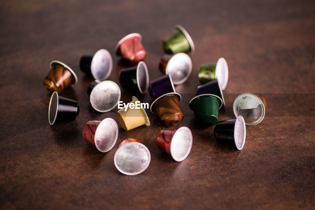 High angle view of multi colored coffe capsules on table