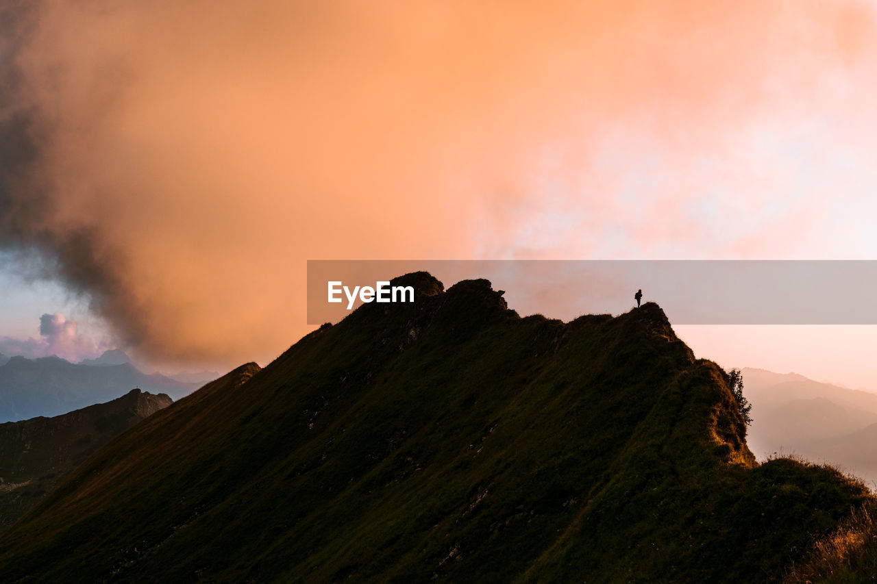 SCENIC VIEW OF MOUNTAIN AGAINST SKY DURING SUNSET