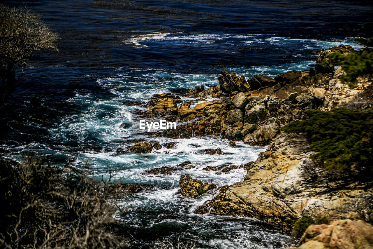 High angle view of rocks on sea