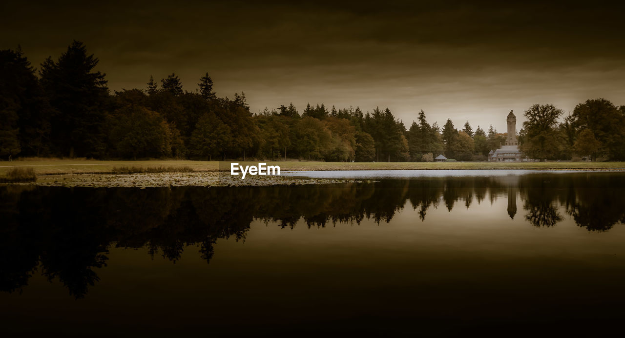 SCENIC VIEW OF LAKE BY TREES AGAINST SKY