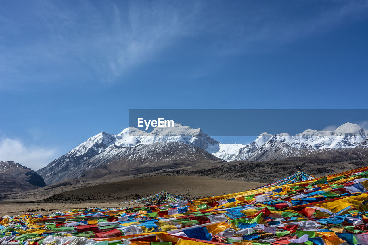 Prayer flags against snowcapped mountains