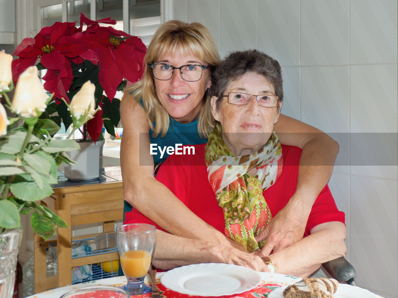 Portrait of smiling woman with mother at home