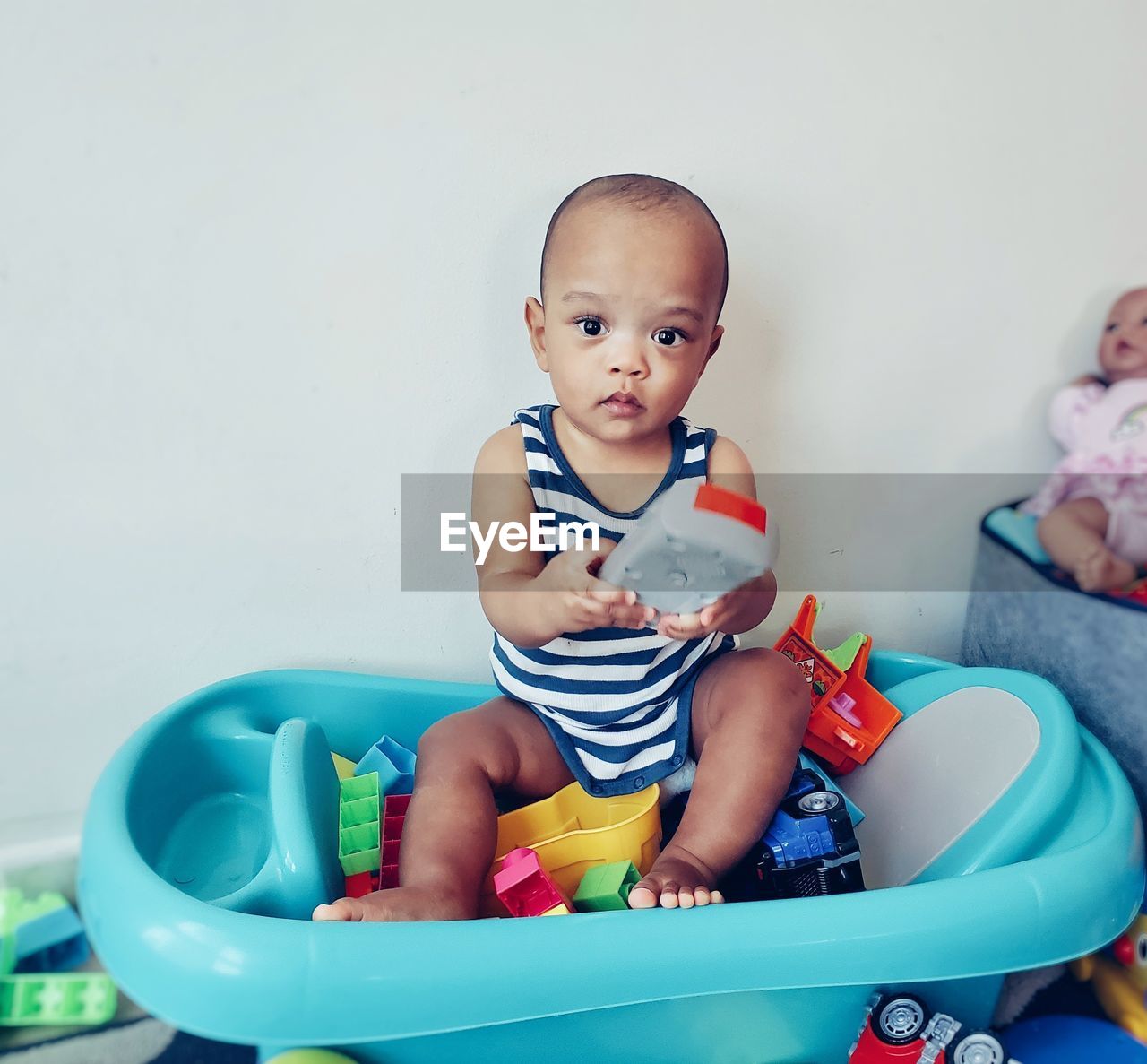 Portrait of cute baby boy sitting in toy