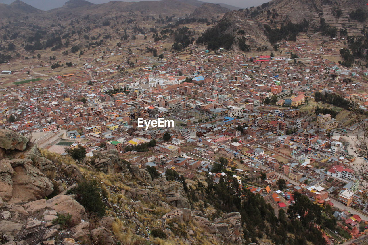 HIGH ANGLE VIEW OF TOWNSCAPE AND MOUNTAINS