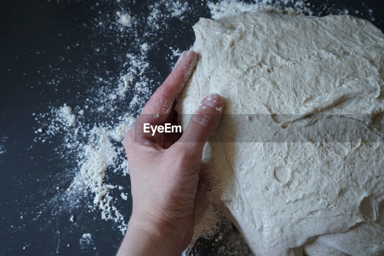 hand, dough, flour, powder, one person, indoors, food and drink, food, icing, high angle view, making, kneading, baking bread, preparing food, lifestyles, adult, freshness, baked, bread, finger, powdered sugar, close-up, directly above, table, bakery