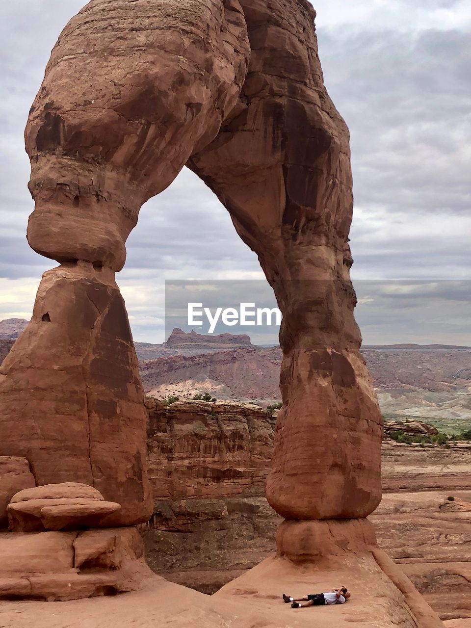 View of rock formation against cloudy sky